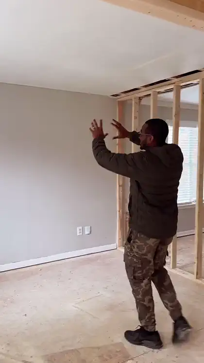 Brandon Williams reviewing renovation plans on a residential jobsite