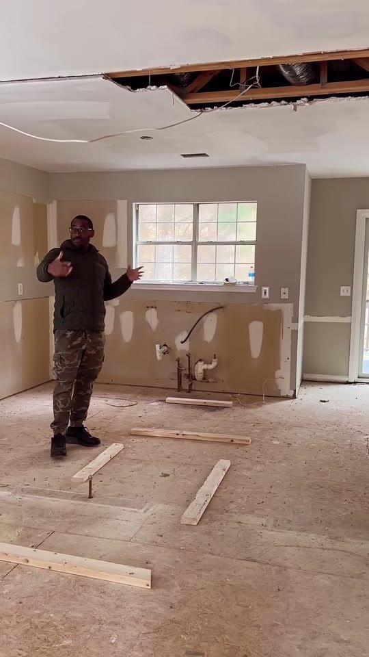 Brandon Williams reviewing renovation plans on a residential jobsite